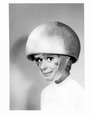 Carol Channing shows how a girl gets rigged out to be shot out of - Old Photo
