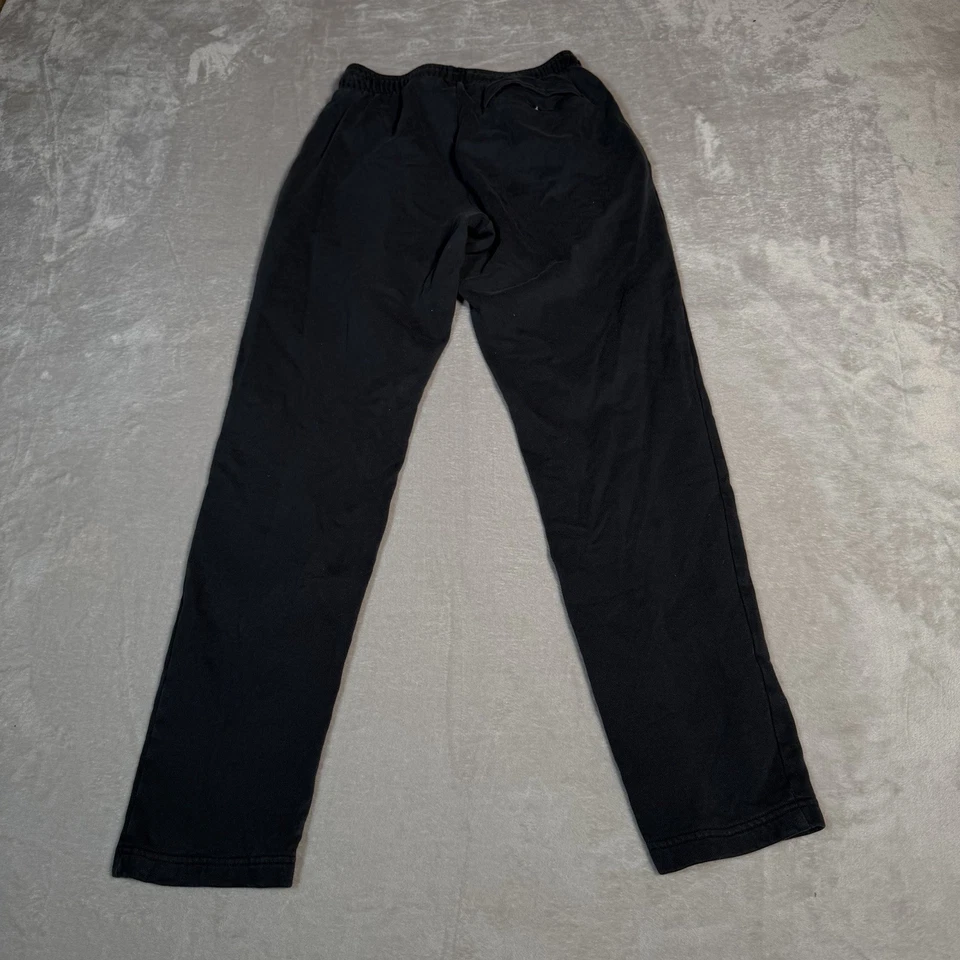 Pantalones deportivos Under Armour para hombre medianos negros lisos rendimiento informales Foto 3 de 4