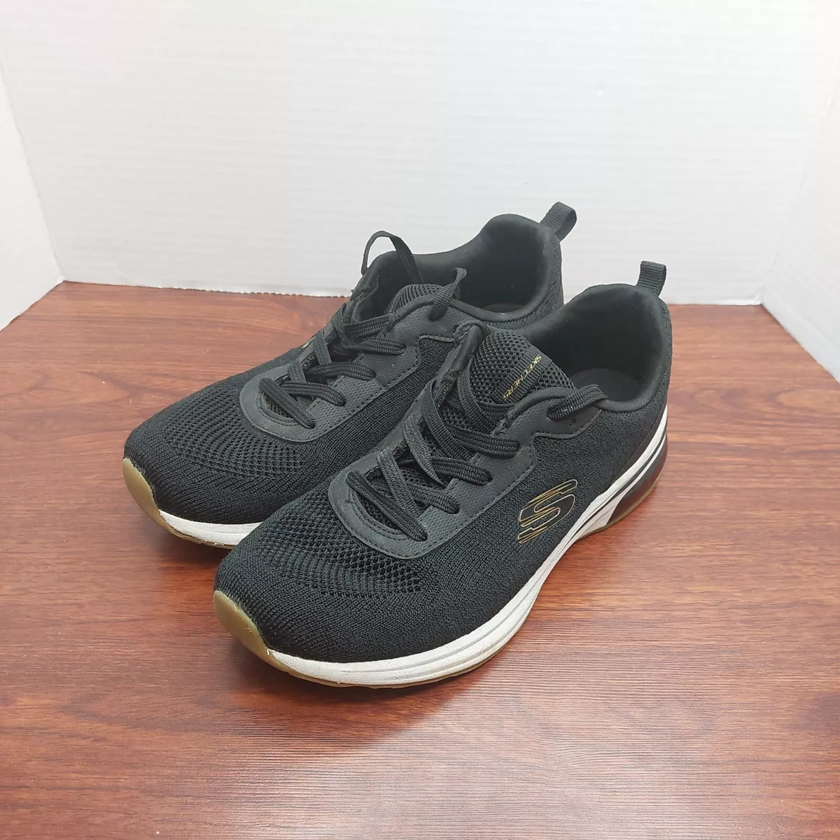 Black and sales gold skechers