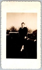 Vtg B&W Snapshot Smiling Woman In Dark Dress And Necklace Outdoors Wall 1940s