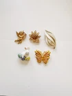 5 Vintage Costume Jewelry Pieces: Brooches. Gold-tone and enamel; all are signed