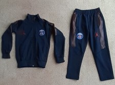 Designer childrens track suit jacket and trousers age 4+ black.