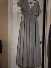sage green Lavetir bridesmaid dress features a V-neckline and ruffled cap...