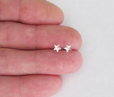 Sterling Silver 4mm dainty Dazzle Star tiny post stud earrings.