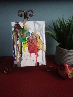 A Abstract Watercolor Mixed Media Painting Featuring A Hand Holding A Spray Can