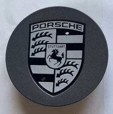 ONE (1) OEM ORIGINAL FACTORY PORSCHE GUNMETAL CENTER CAP BADGE. MADE IN ITALY.