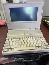 Compaq LTE 286 Laptop Series, Beige, with a carrying case.