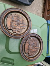 PAIR OF FOREIGN POTTERY PLATES WITH RAISED CASTLE PICTURES ON.