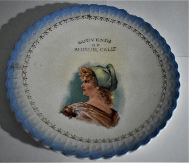  An early souvenir plate from Suisun City Calif.It has a woman portrait on it