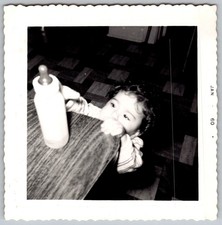 Vtg B&W Snapshot Baby Reaching For Bottle On Table Kitchen Floor 1960
