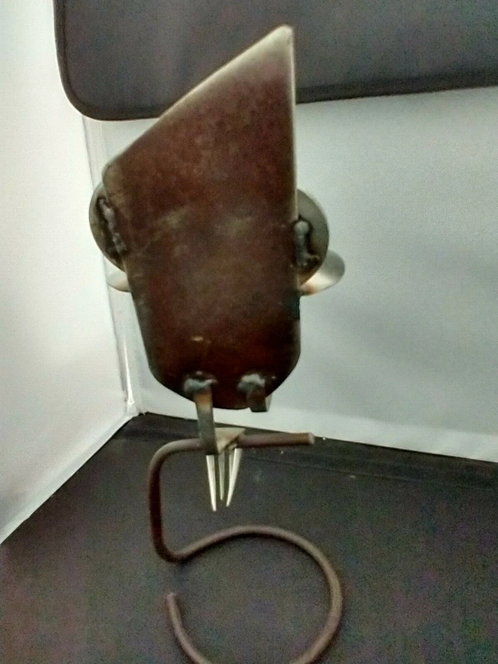 Búho esculpido sentado en soporte hecho de cucharas, tenedores, arandelas y metal Foto 4 de 4