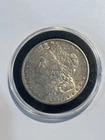 1885 O $1 Morgan Silver Dollar in coin capsule uncirculated New Orleans Mint.