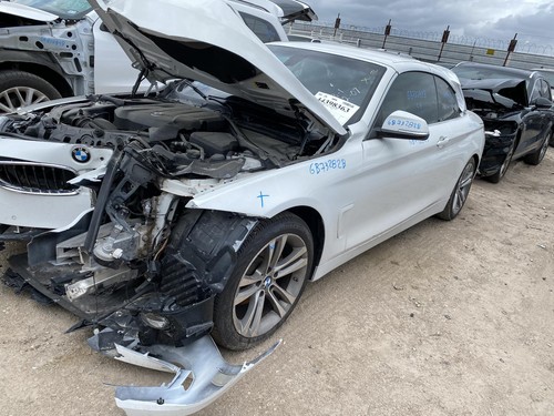 White 2018 BMW 430I with black roof, side door mirror, and visible BMW logo on front grille.