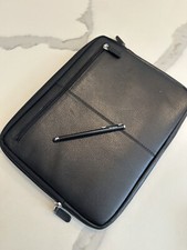 Sleek black laptop sleeve with padded interior and exterior zip pocket Travel