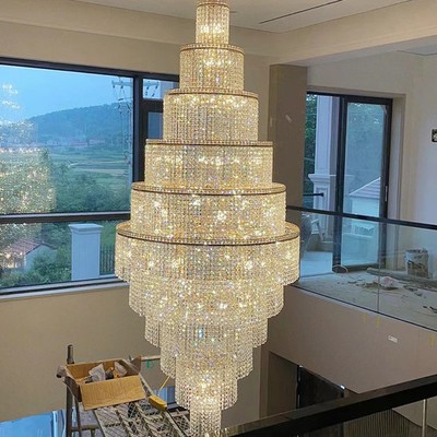 Staircase with long crystal chandelier, villa with openwork living room lamp