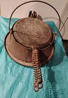 Tall Bottom Marked Stand on a Cast Iron Waffle Iron with Slanted Griswold.