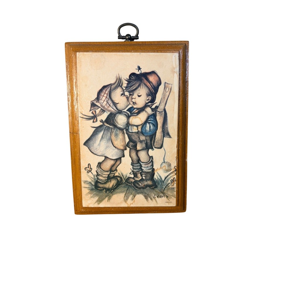 A genuine 1972 MCM lithograph wood plaque of kissing children in Hummel style — the kind of charming kitschy wall art that stops thrift-store hunters in their tracks.