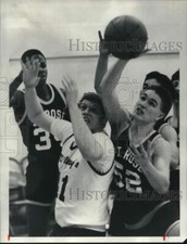 1987 Press Photo St Rose basketball player Dennis Cavanaugh grabs ball in game
