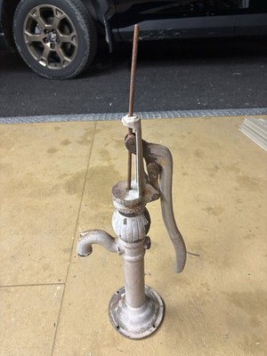 This vintage cast-iron pitcher pump is likely a model 