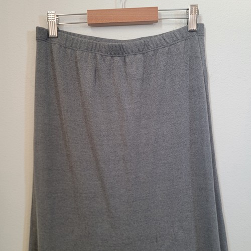 Grey maxi flowy skirt with elastic waistband, tiered skirt design, and “Made in USA” label on hanger against white wall.