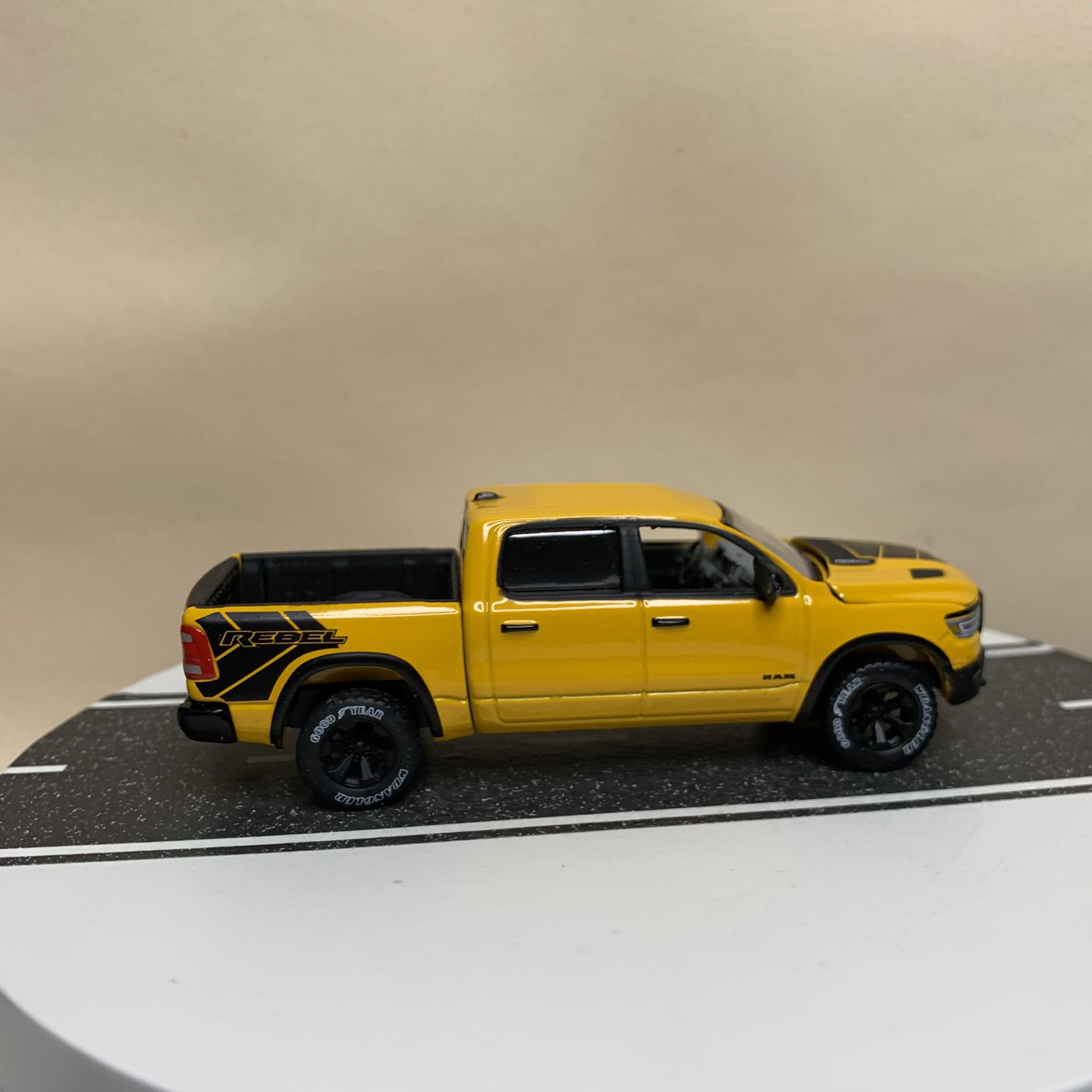 Auto World Muscle Trucks 2019- 2023 Ram 1500 Rebel DT Pickup Truck Yellow 1:64