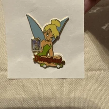 Disneyland Tinkerbell Holding A Pic Of Peter Pan 