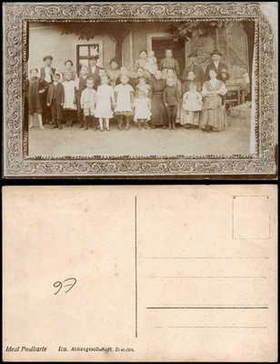 Large family group in front of a residential building, many children, celebration 1915