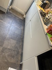 Howdens kitchen wall units in white gloss and base units in light grey gloss