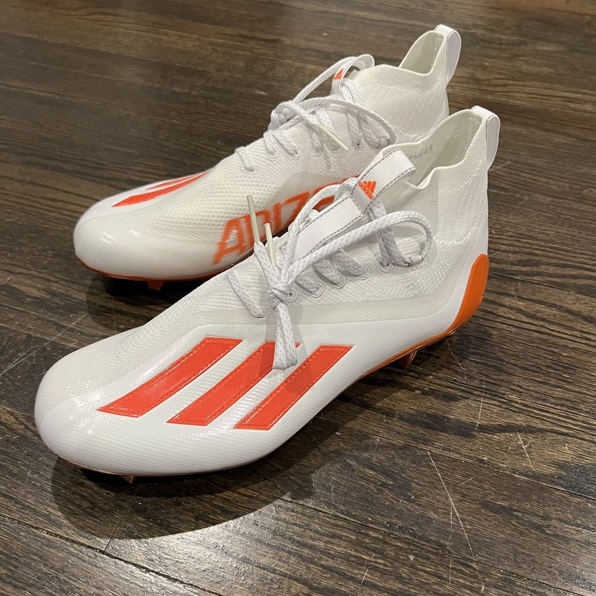 Orange and white adidas football deals cleats