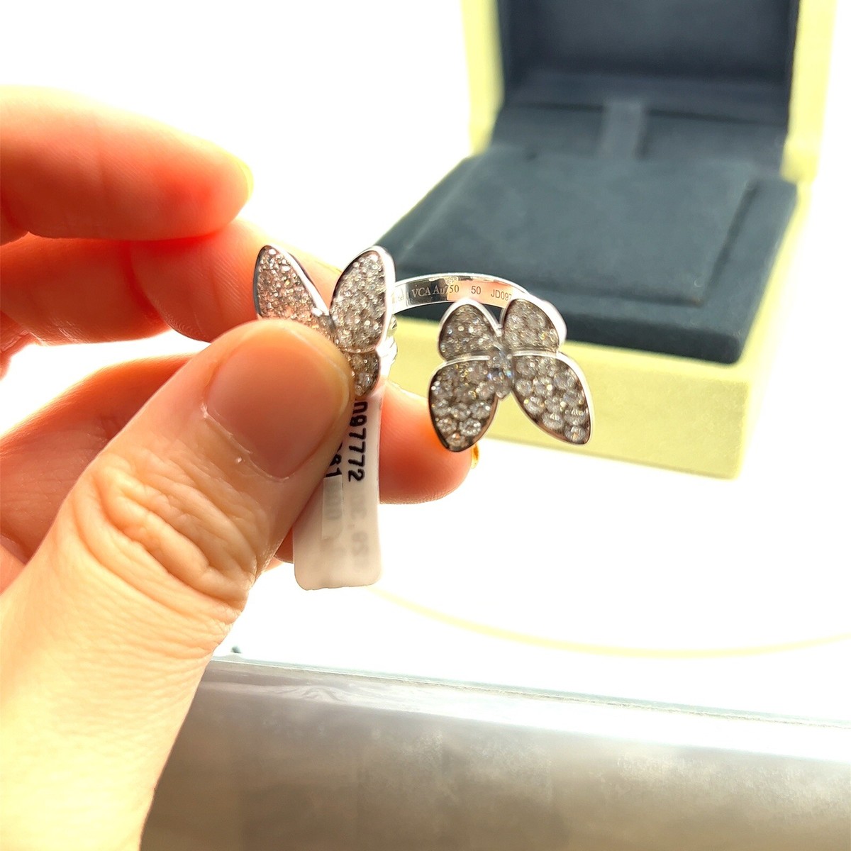 two butterfly between the finger ring