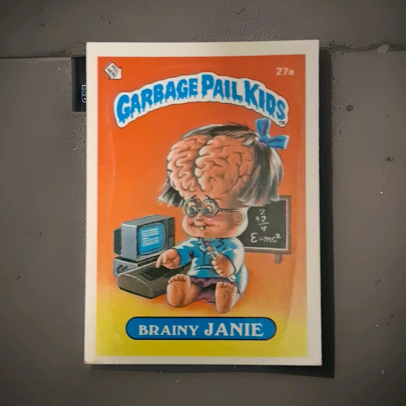 Topps 1985 Garbage Pail Kids Brainy Janie Janie #27a Sticker Trading Card