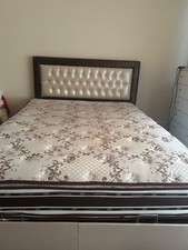 double bed with mattress and storage
