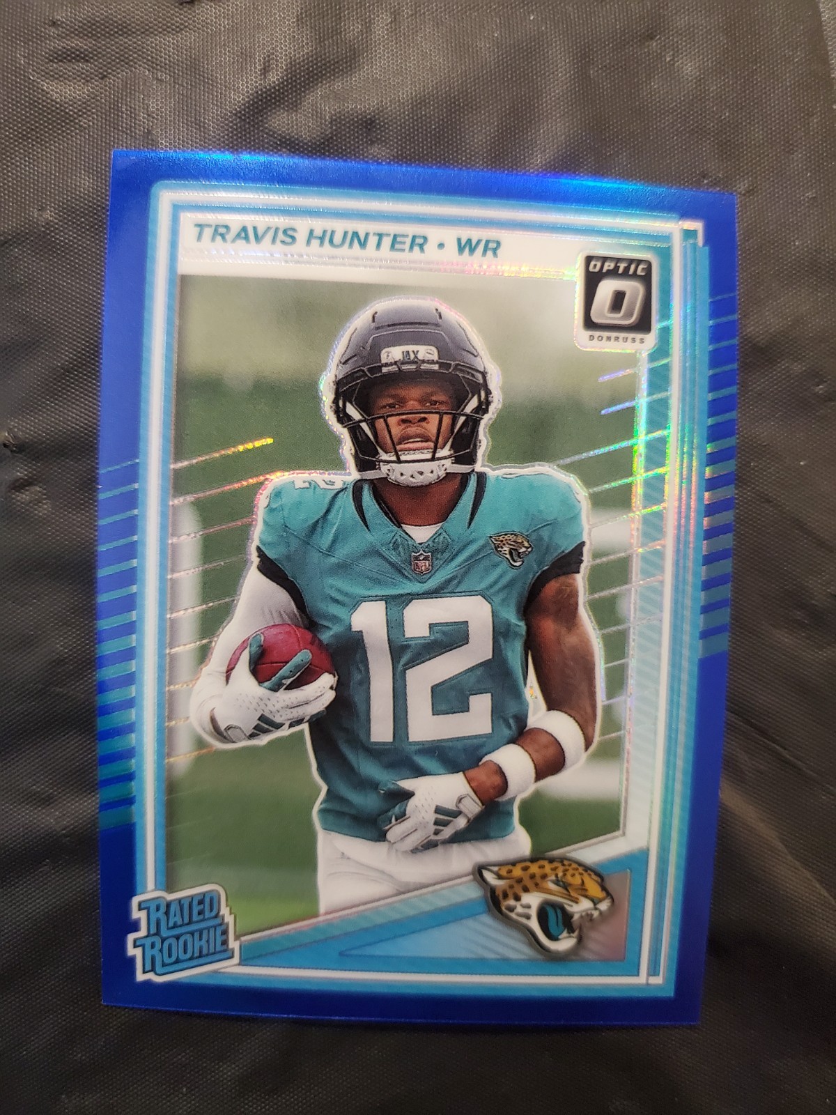 2025-26 Donruss Optic Travis Hunter #201 Rated Rookie Blue Prizm 155/249 (RC)