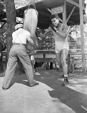 Boxer Henry Armstrong steadies punching for Joe Louis at Louis tra- Old Photo