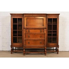 Antique English Jacobean Carved Oak Glass Front Double Bookcase, Circa 1920s