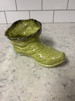 Vintage lime green ceramic pixie boot planter with a mottled rim.