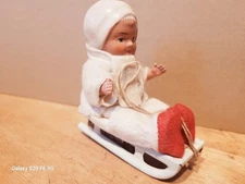VERY NICE VINTAGE  WIND UP CHILD ON A TIN SLED  made in  GERMANY