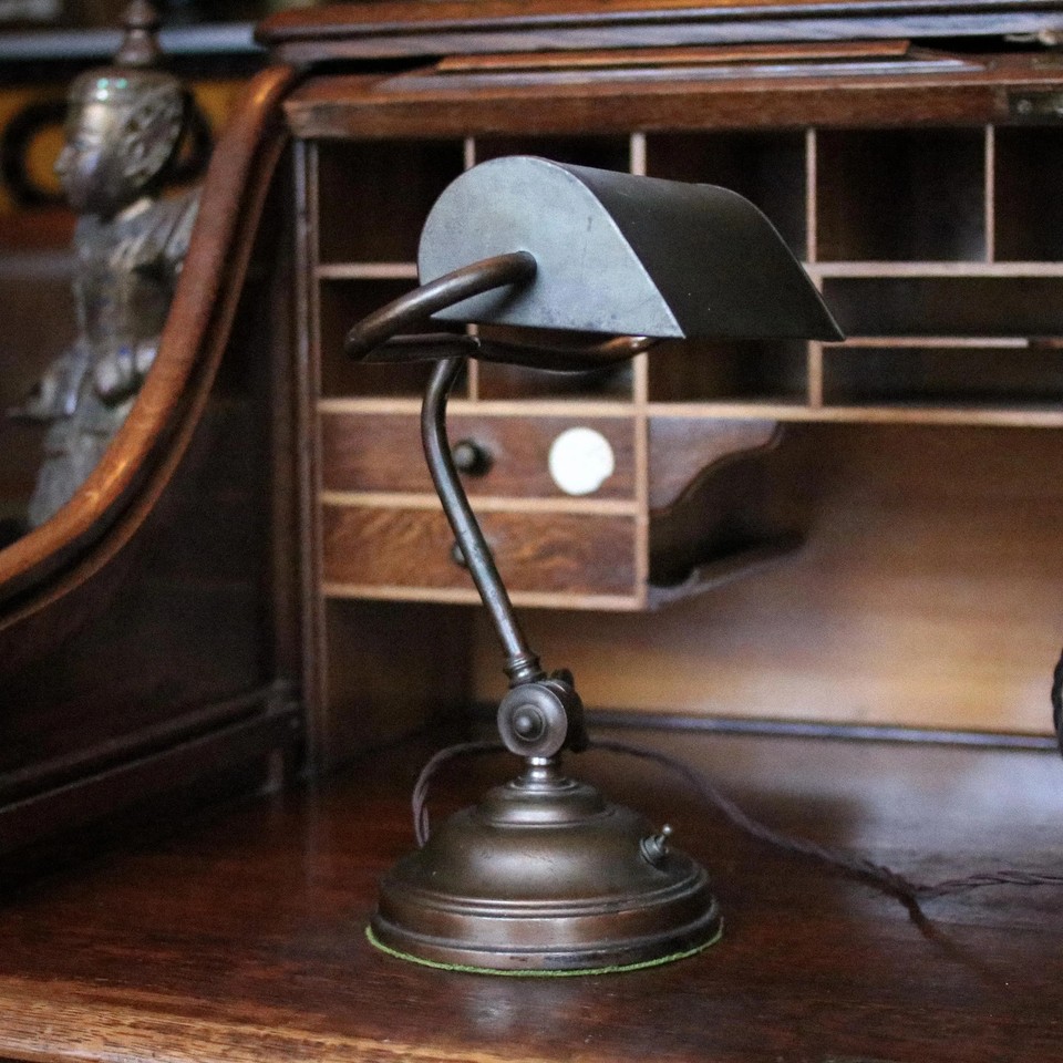 A genuine c.1920s adjustable brass bankers library lamp — the gold standard of atmospheric desk lighting, and it's the real deal.