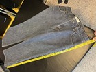 AX Armani Exchange J40 women’s blue short regular bootleg jeans with yellow measuring tape across the waistband.