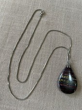 Tiger iron eye pendant mounted on a silver chain