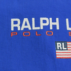 Blue Vtg 90s Polo Sport Ralph Lauren jacket with white “RL” text, USA flag stripes, and red shoulder panels.
