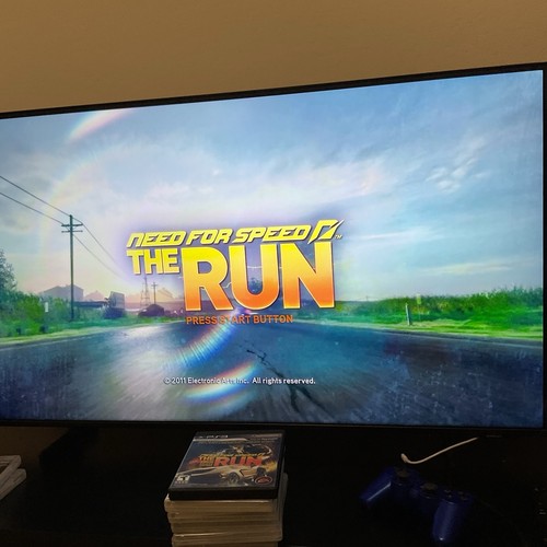 PlayStation 3 Need for Speed Most Wanted Hot Pursuit Rivals Run cover with neon-lit road and surrounding scenery.