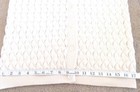Cream knit women's long sleeve sweater with scalloped textured pattern and front button closure, made in USA.