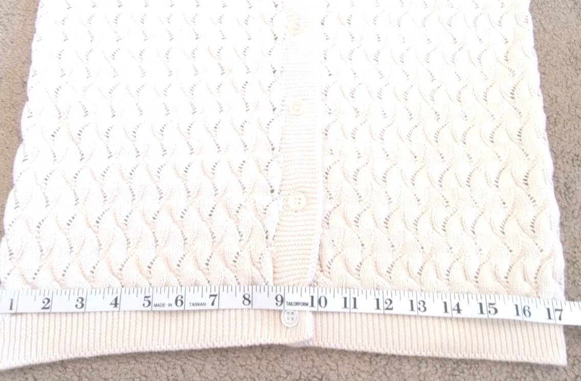 Cream knit women's long sleeve sweater with scalloped textured pattern and front button closure, made in USA.