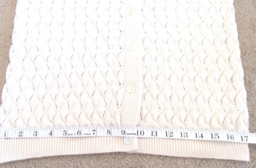 Cream knit women's long sleeve sweater with scalloped textured pattern and front button closure, made in USA.