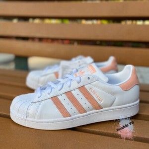 white adidas with pink back