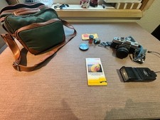 Minolta SRT 101 camera with Vivatar flash, bag and other accessories