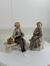 2 Vintage Old Man And Woman Sitting On There Benches