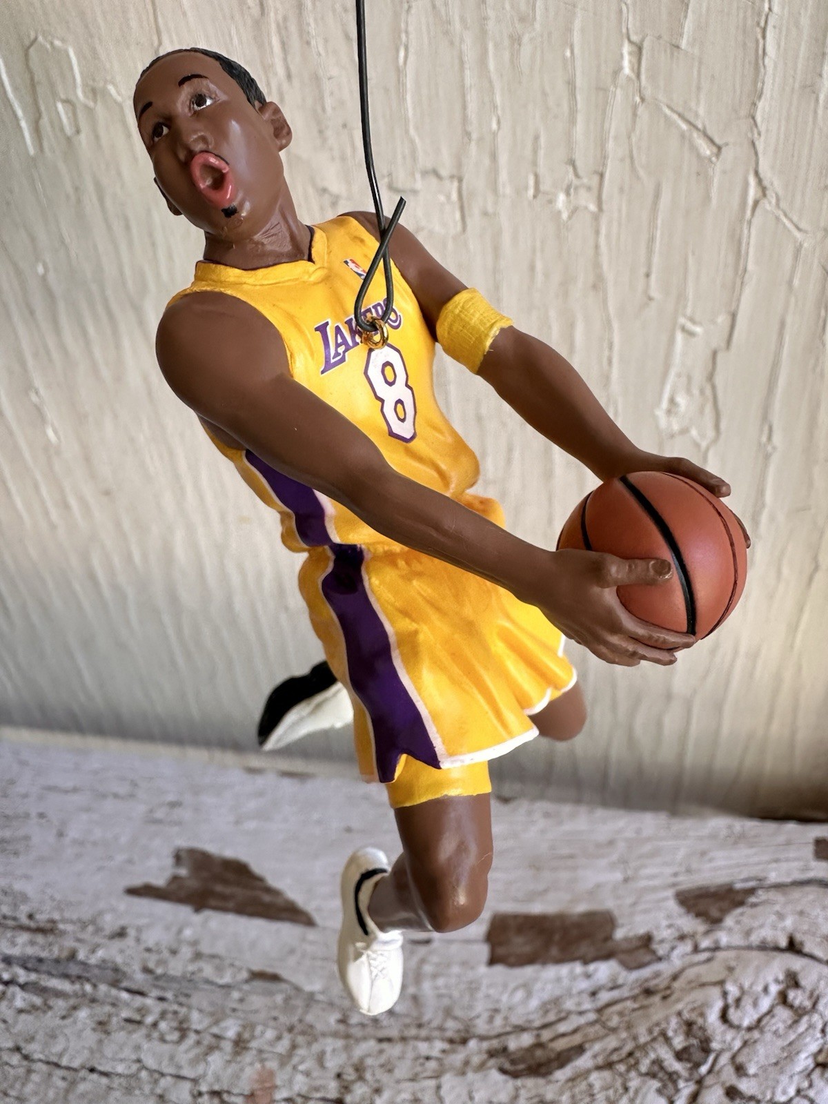 2003 Hallmark Hoop Stars ornament of Kobe Bryant in yellow Lakers uniform holding basketball, white shoes, purple jersey.