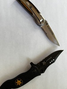 Two pocket knives, one Winchester and Sheriff folding one blade.
